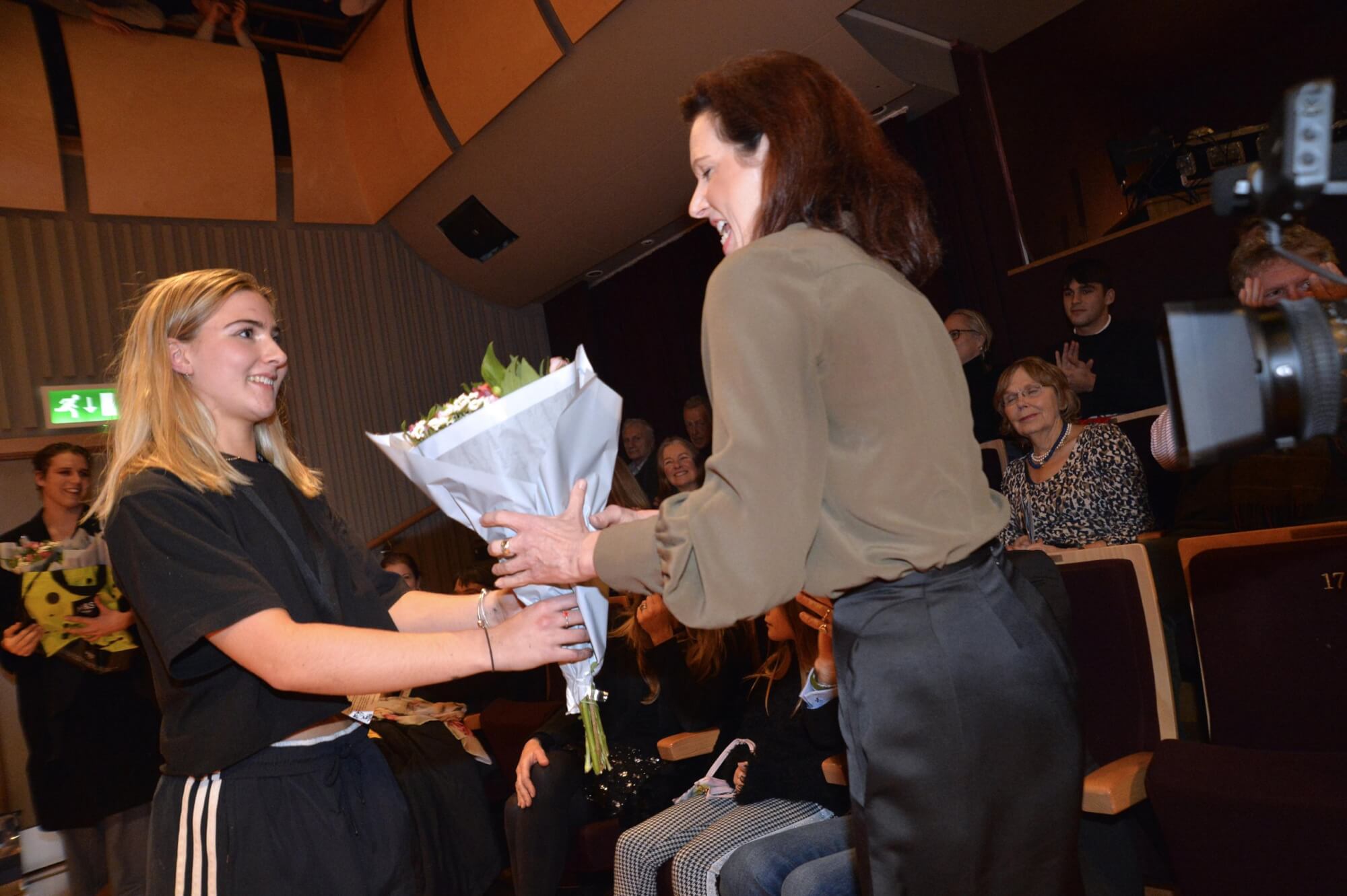 sasha marlow receives a bouquet for her fashion show