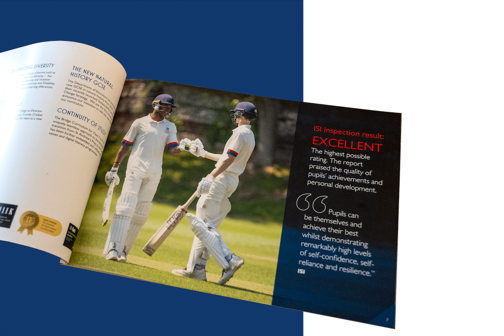 An open magazine displays a photo of two cricket players in white kits and helmets on a grassy pitch at an independent school in Sussex. The opposite page features a bold EXCELLENT rating and a quotation about pupil achievement and resilience.