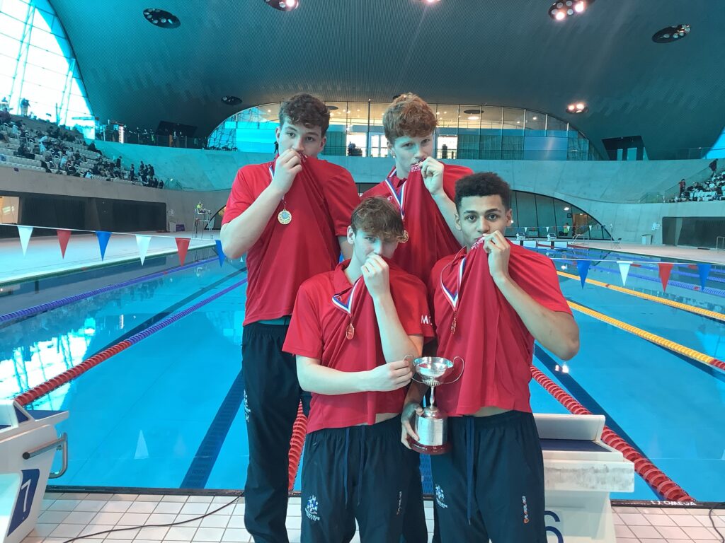 Swim team celebrating nationals double gold