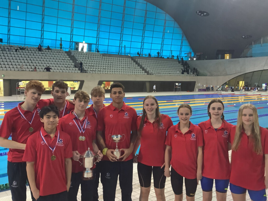 Swim team celebrating double gold win